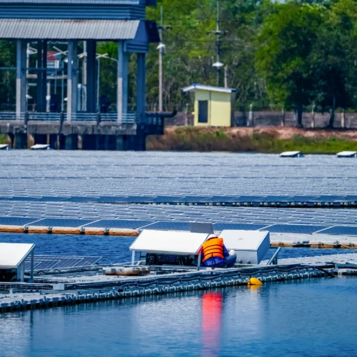 local-worker-working-at-floating-solar-panels-plat-2024-02-27-21-55-28-utc